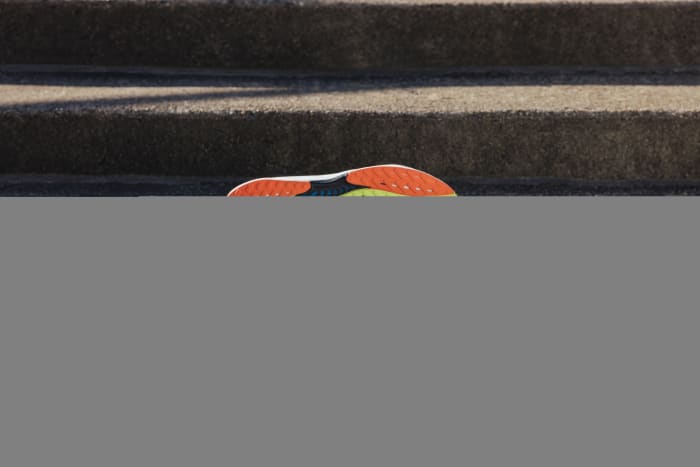 View of blue and orange Reebok shoes.